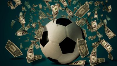 a soccer ball with a lot of money flying around it