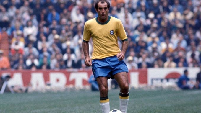 a man in a yellow and blue uniform playing soccer