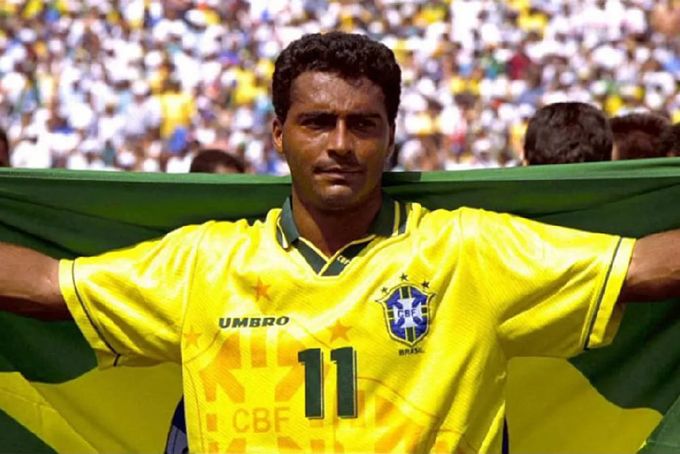 a soccer player holding a flag in front of a crowd