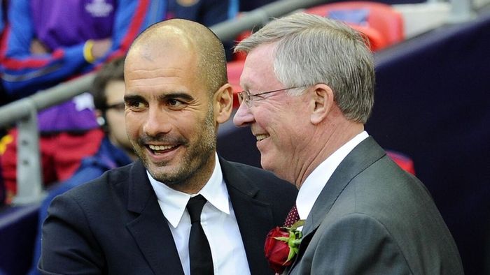 a man in a suit and tie sitting next to another man