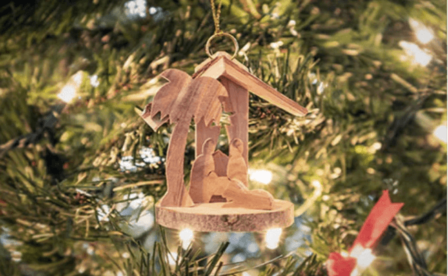 a wooden ornament hanging from a christmas tree