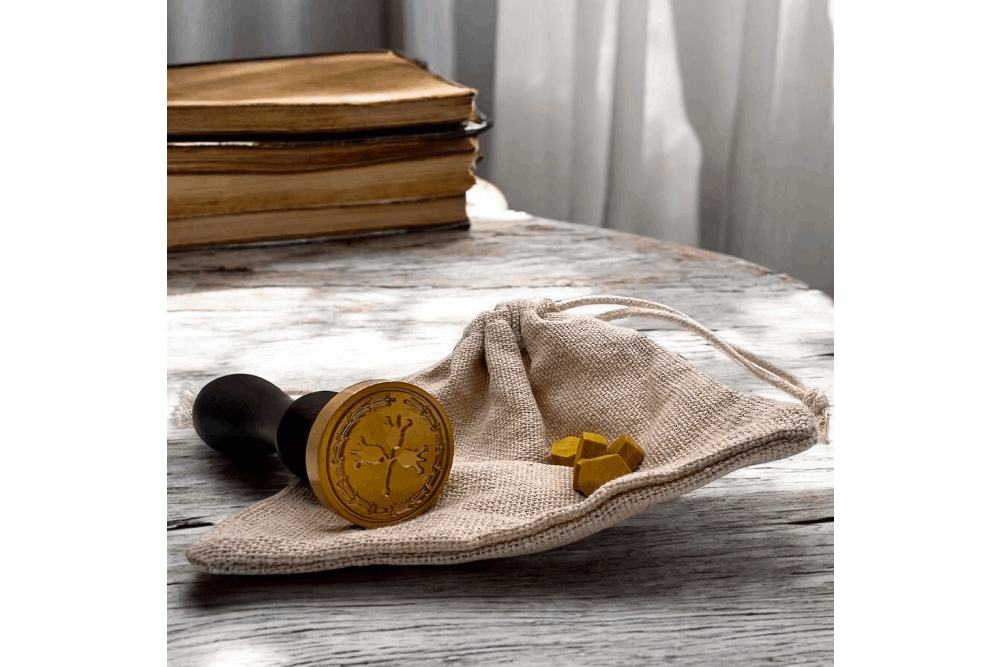 a wooden table topped with a bag and a clock