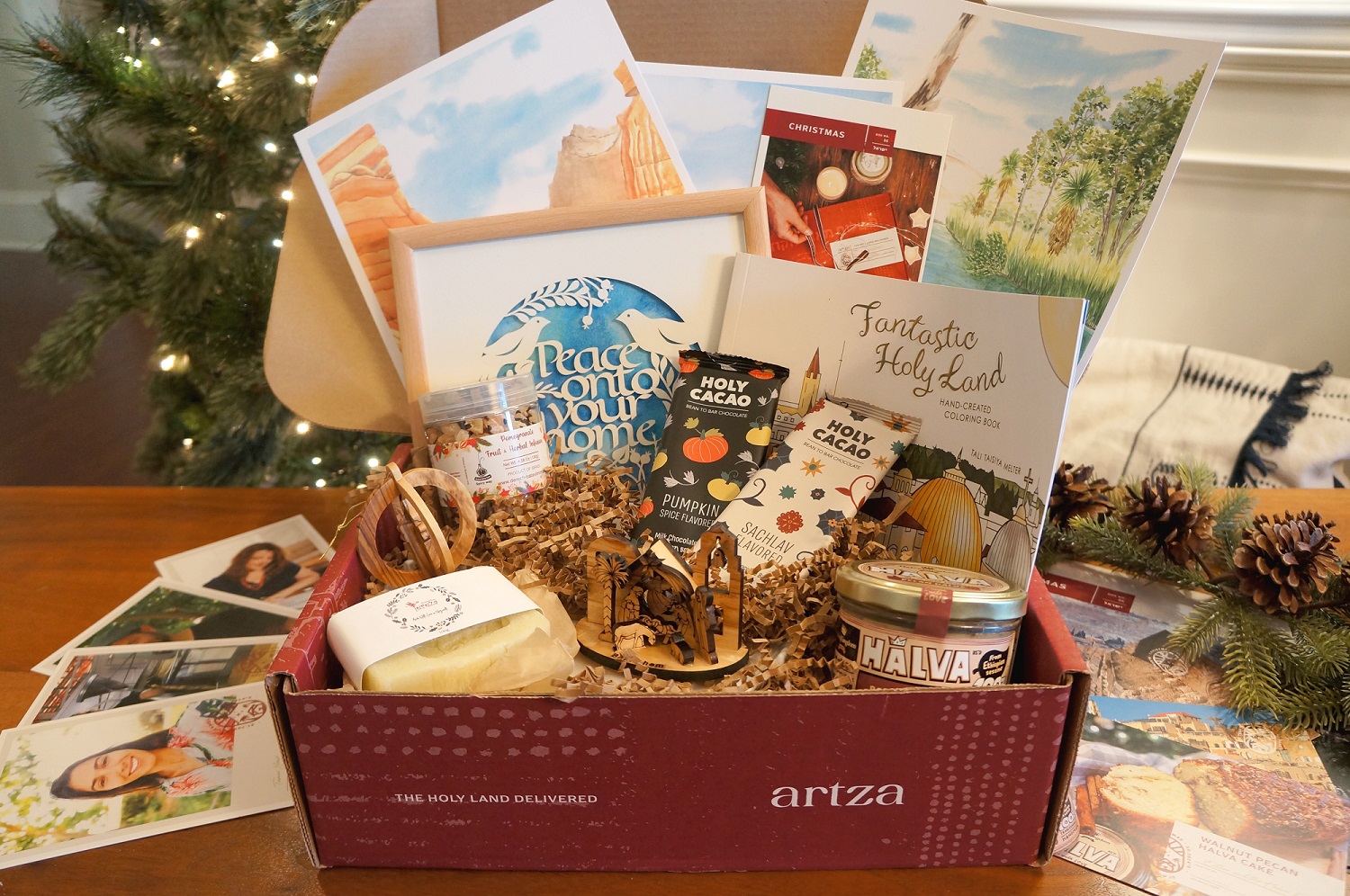 Open Artza Christmas box showing products and photographs of their artisans