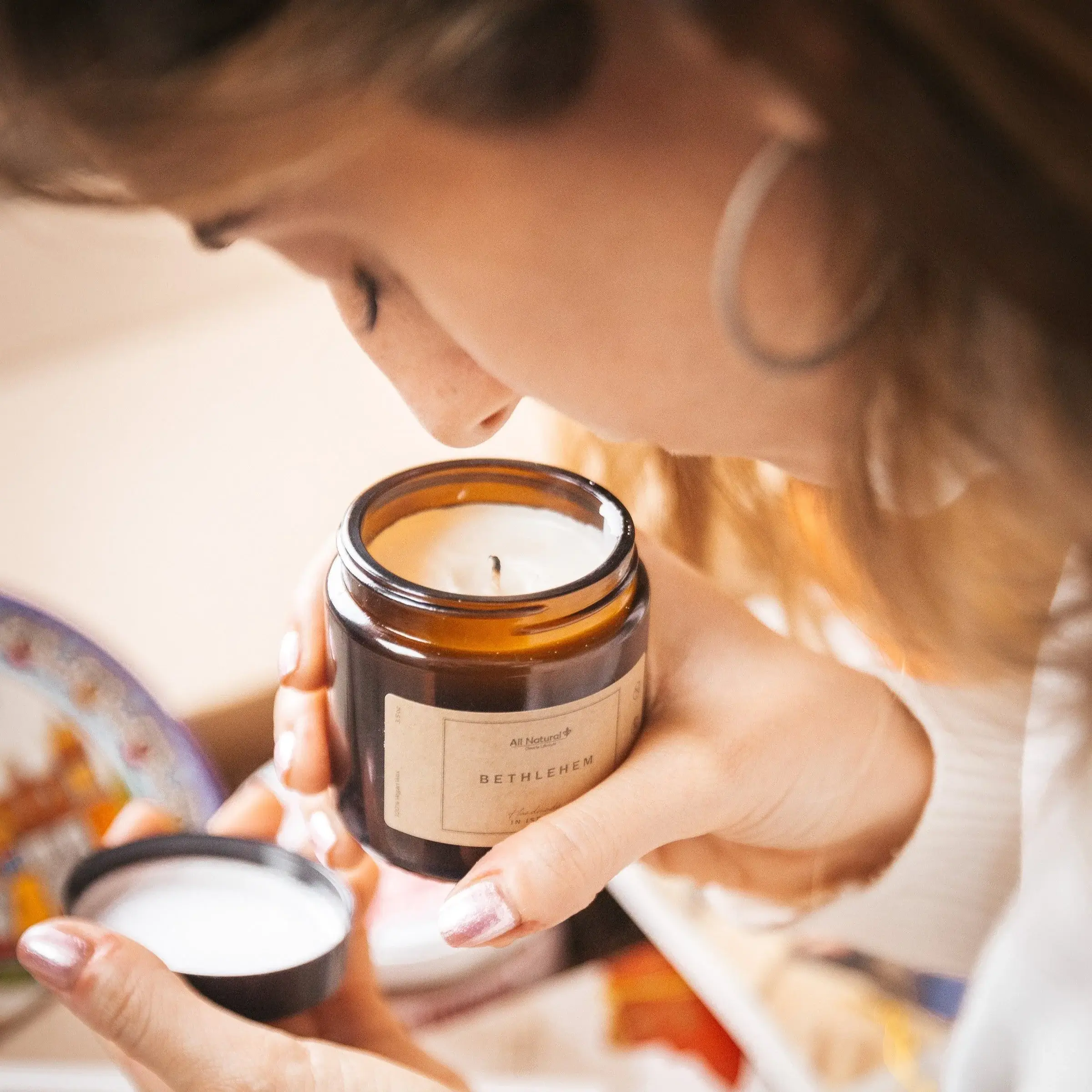 a woman holding a candle in her hands