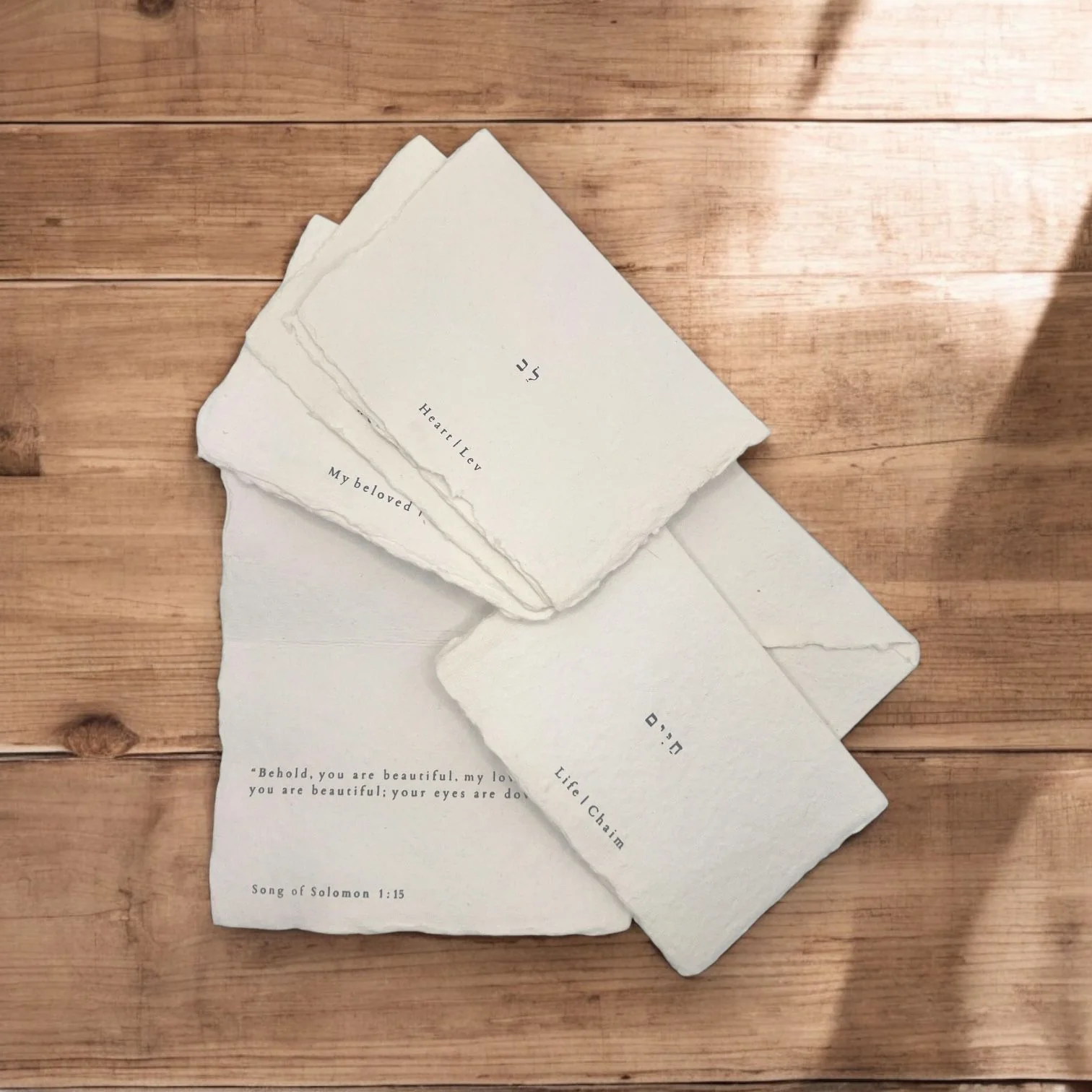 a stack of papers sitting on top of a wooden table