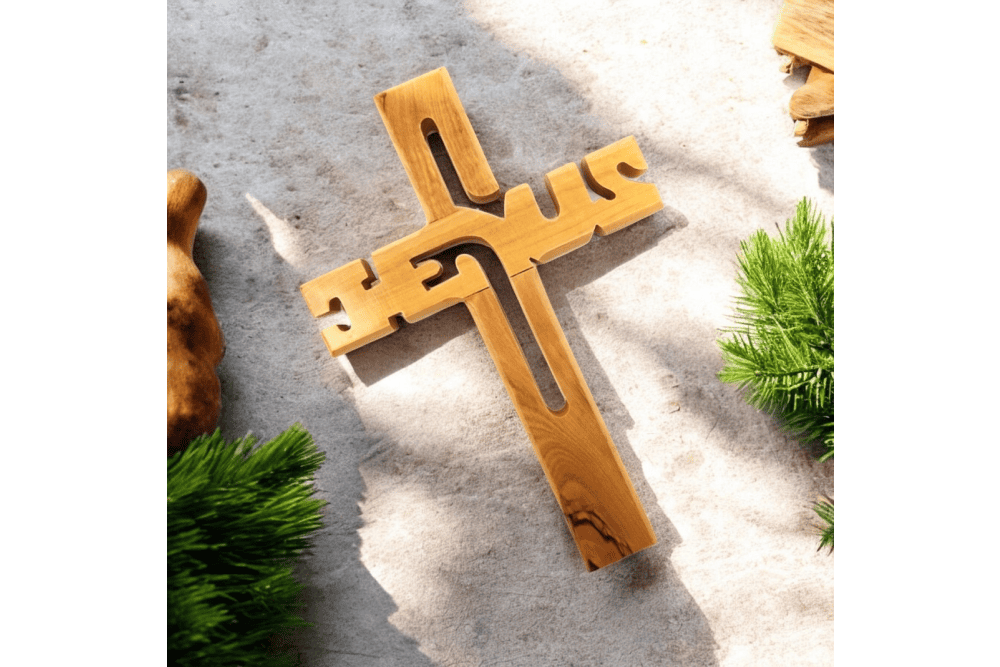 a wooden cross sitting on top of a cement ground