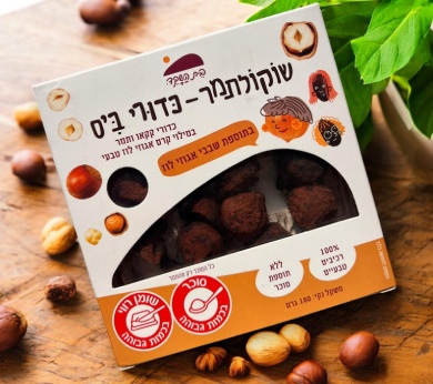 a box of nuts sitting on top of a wooden table