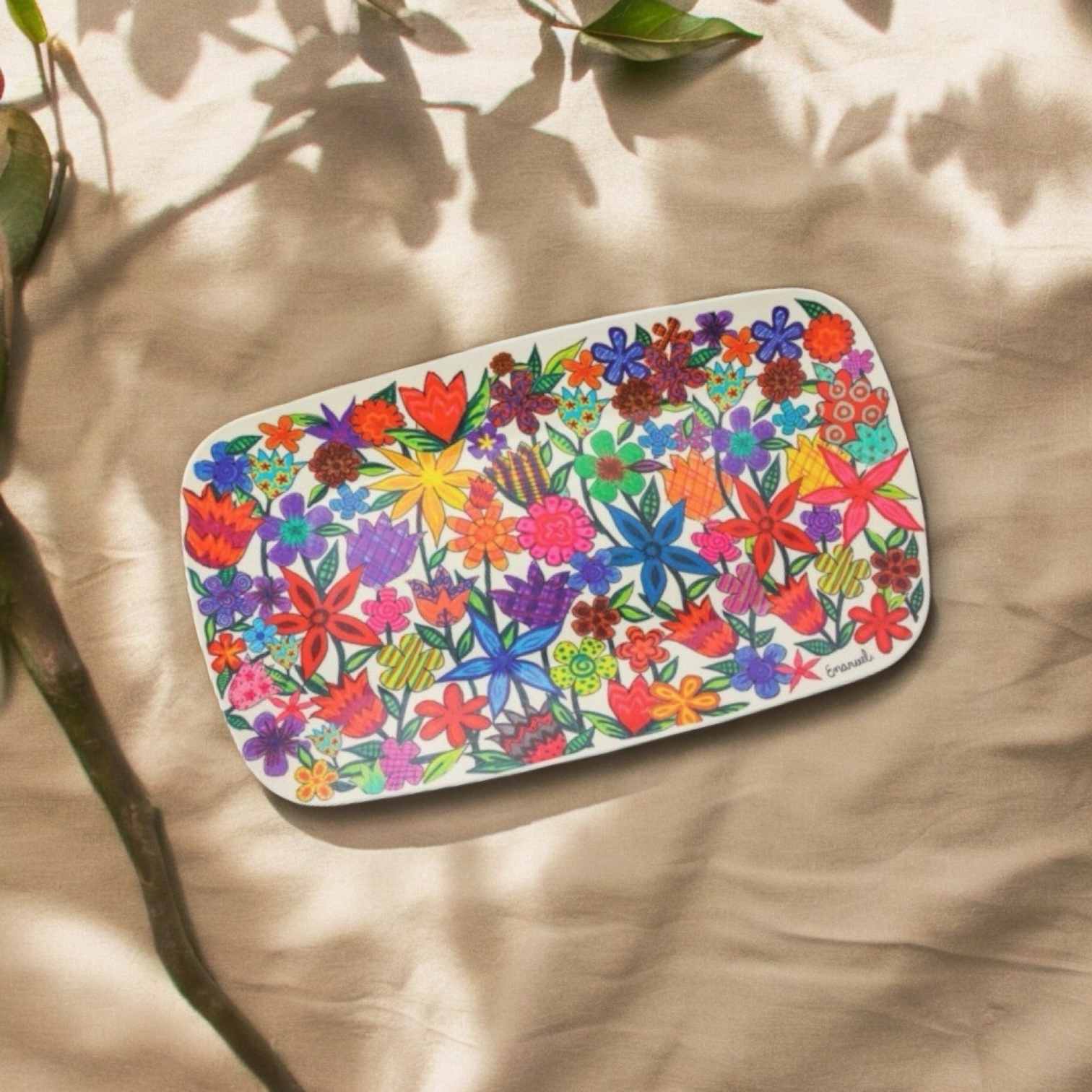 a white tray with colorful flowers painted on it