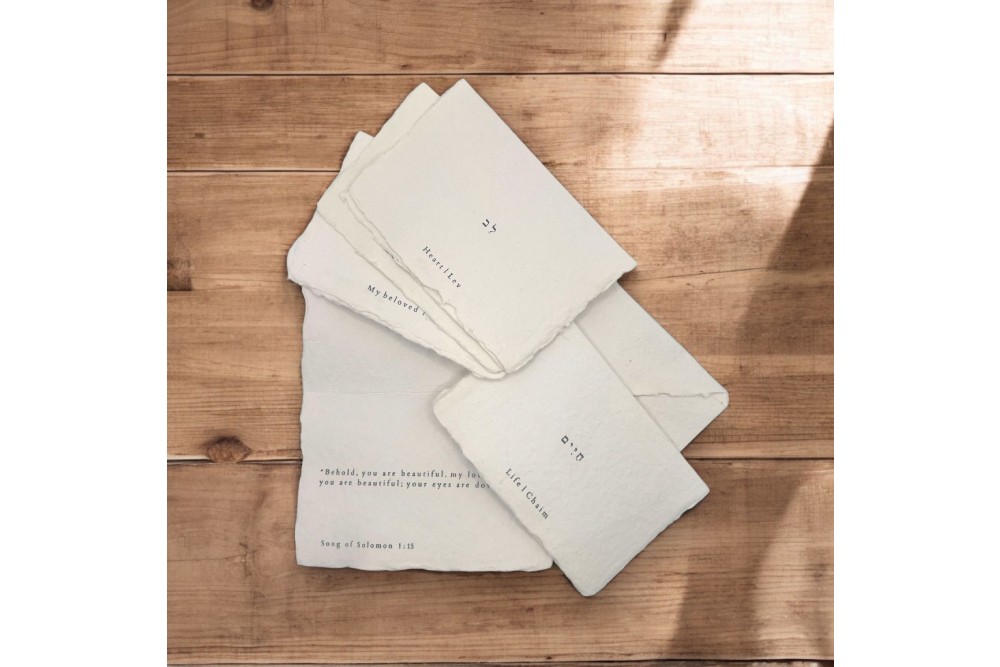 a stack of white napkins sitting on top of a wooden table