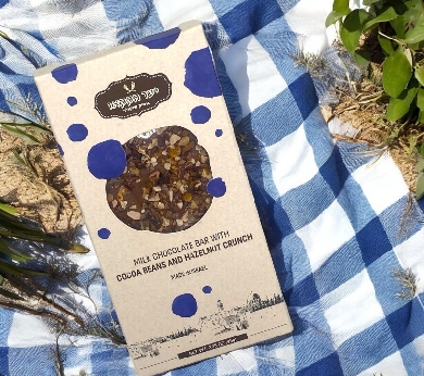 a box of granola sitting on top of a blue and white checkered blanket