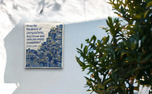 a blue and white tile hanging on the side of a building