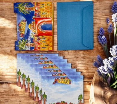 a table topped with cards and a vase of flowers