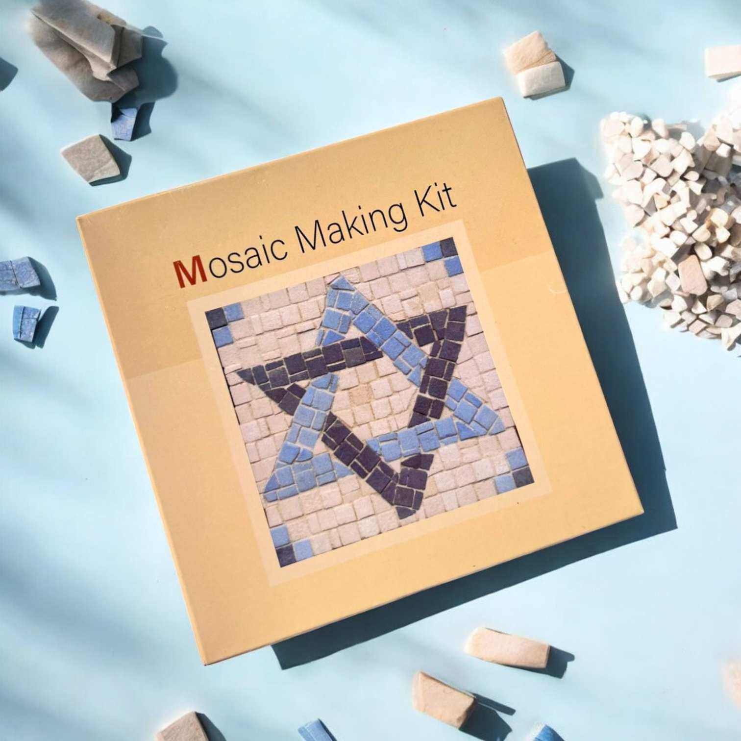 a mosaic making kit on a blue surface