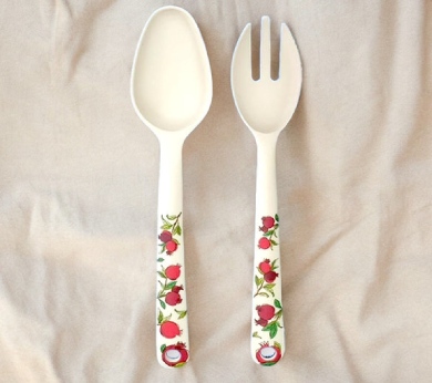 a couple of forks and a spoon on a bed