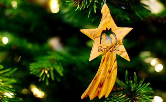 a wooden ornament hanging from a christmas tree