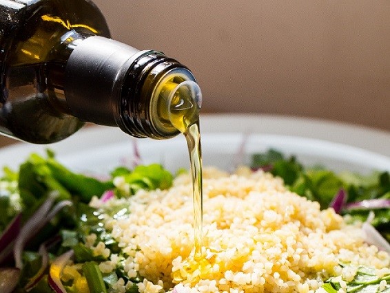 Olive oil being poured over food