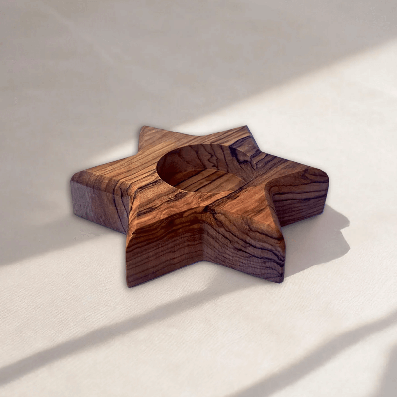 a wooden object sitting on top of a white surface