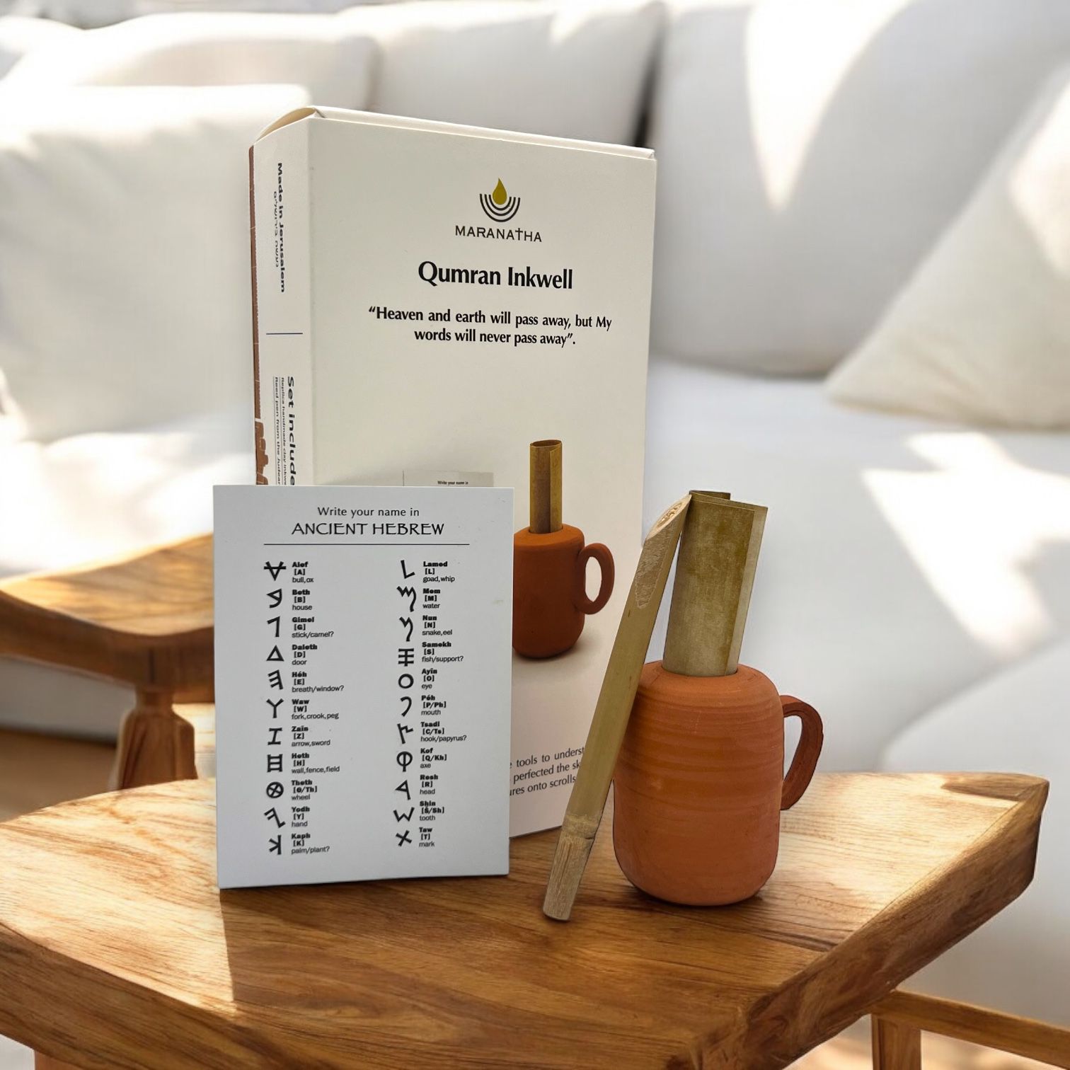 a wooden table topped with a book and a vase