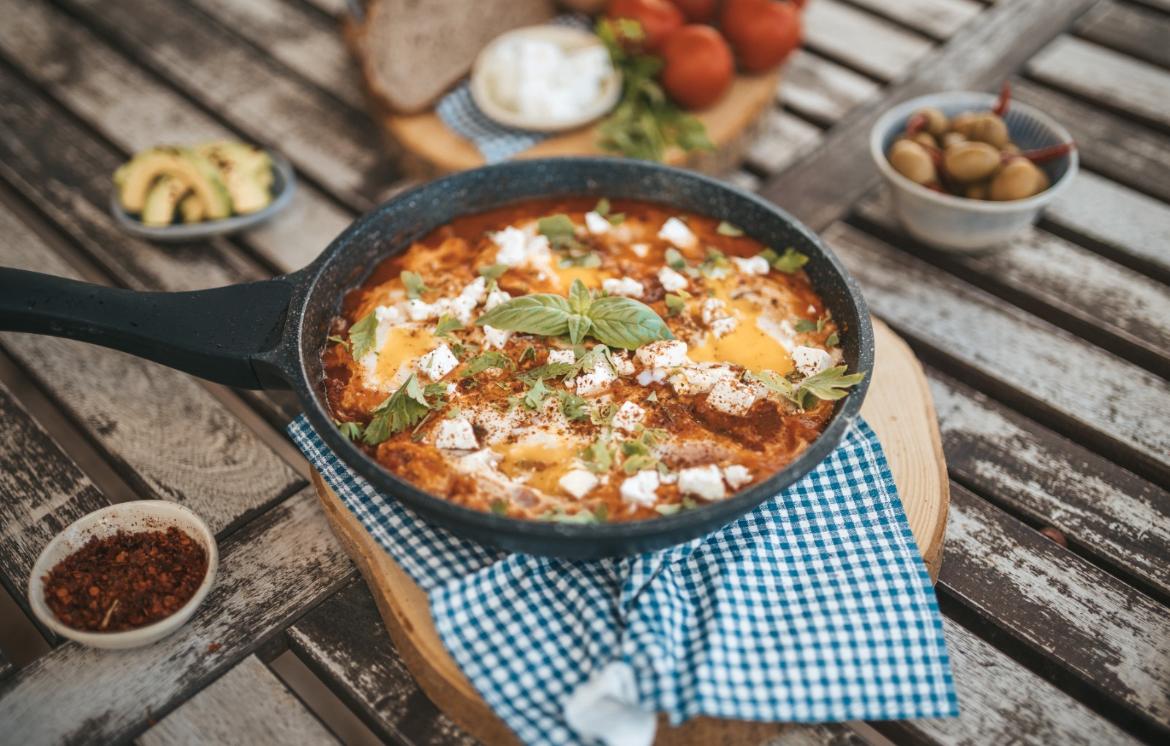 a pan of food sitting on top of a wooden table