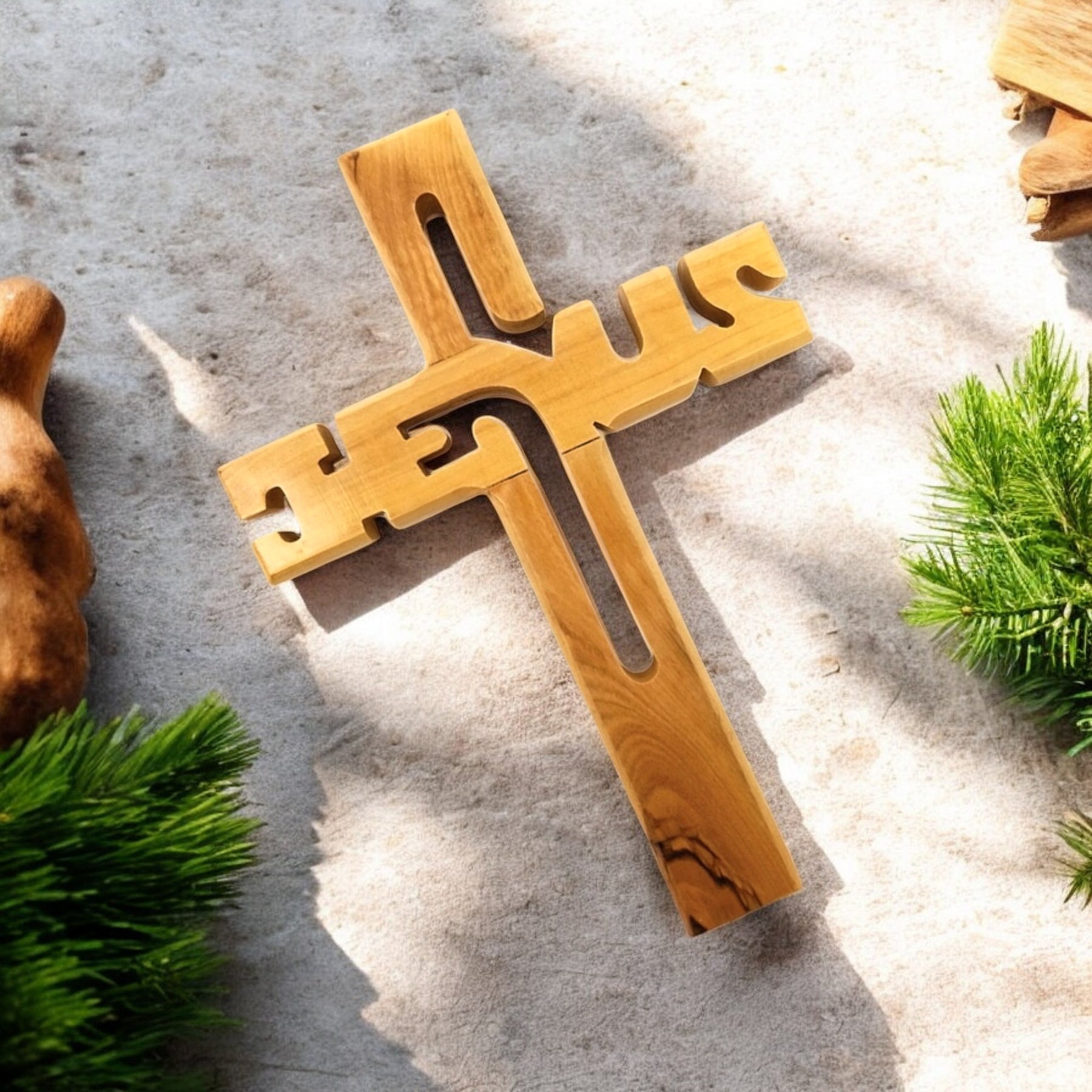 a wooden cross sitting on top of a sandy ground