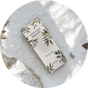 a tube of toothpaste sitting on top of a white towel