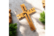 a wooden cross sitting on top of a cement ground