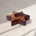 a wooden object sitting on top of a white surface