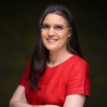 a woman wearing glasses and a red shirt