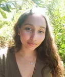 a woman is posing for a picture in the woods