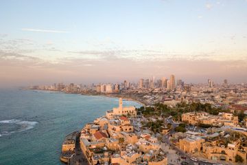 An aerial view of a city next to the ocean.