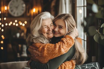 A grandma hugging her granddaughter.