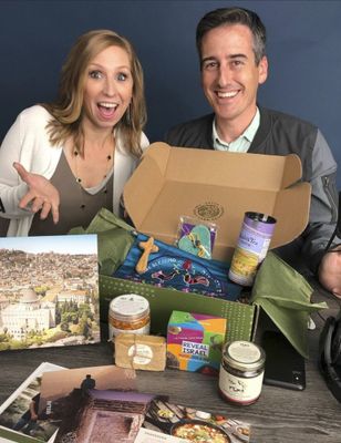 a man and a woman holding a box of food