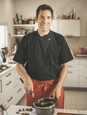 a man standing in a kitchen preparing food