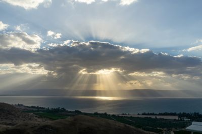 the sun is shining through the clouds over the ocean