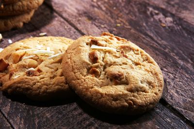 a close up of two cookies on a wooden table