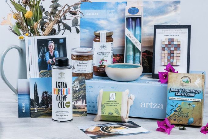 A table topped with items from the Artza Christian subscription box.