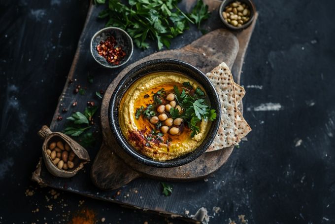 a bowl of hummus with spinach and chickpeas