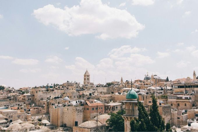 A view of a city with a green dome.