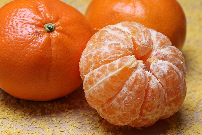 Two oranges sitting next to each othe.