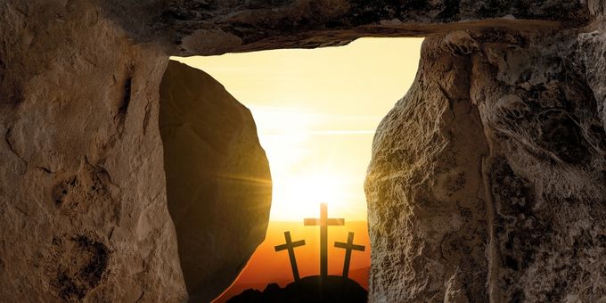 View from a tomb with stone door and three crosses beyond