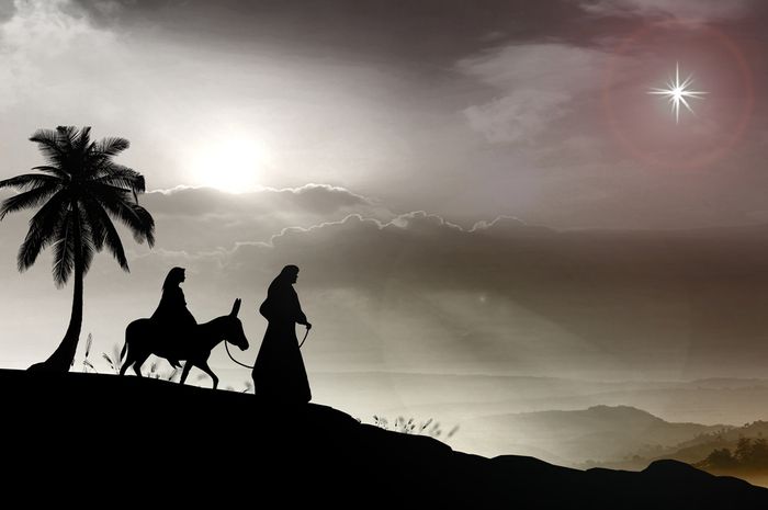 Silhouette of Joseph and Pregnant mary on a donkey travelling to Bethlehem