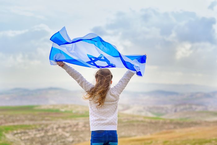 a young girl holding a blue and white flag preview image