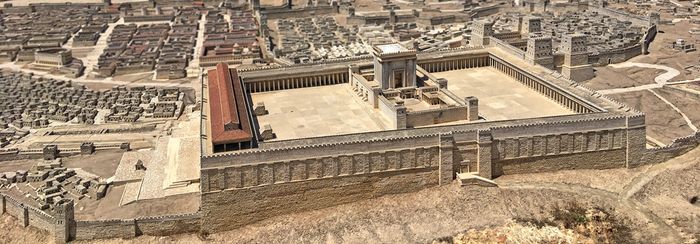 an aerial view of a city with a large building