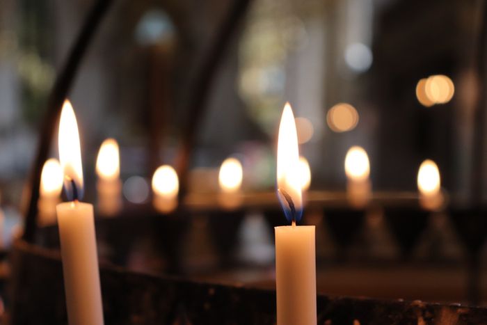 a group of lit candles sitting on top of a table