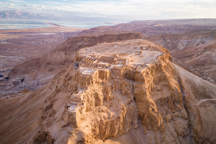 Masada Israel an aerial view of a desert with a mountain in the background
