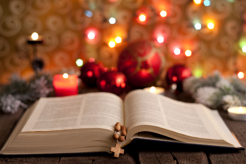 Open bible and Christmas ornaments