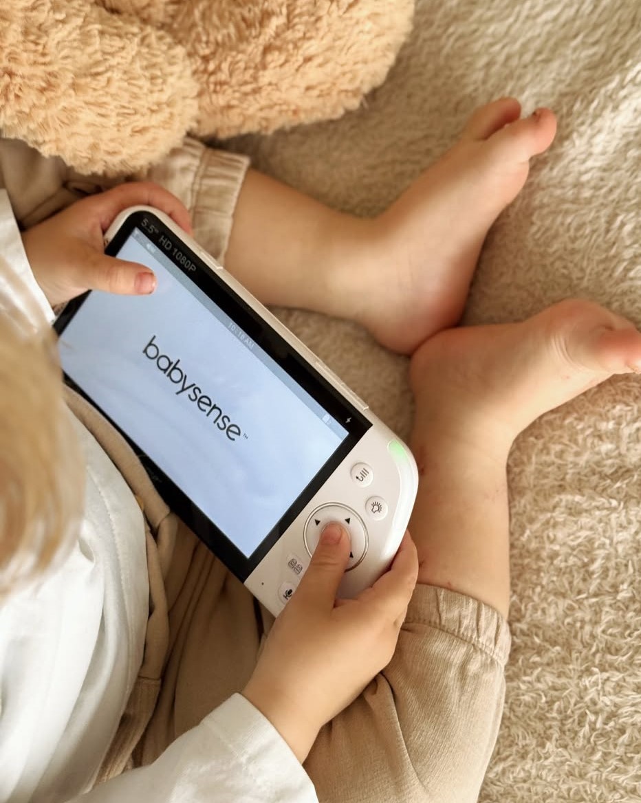 a child is playing with an electronic device