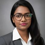 a woman in a suit and glasses posing for a picture