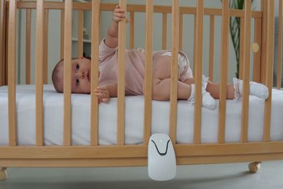 A Babysense motion and breathing monitor on a crib.