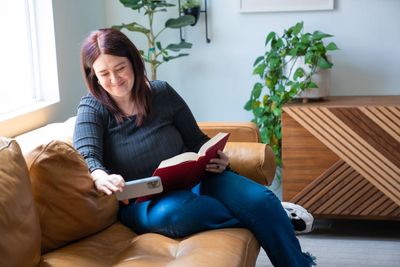 A woman reading up on Nesting.